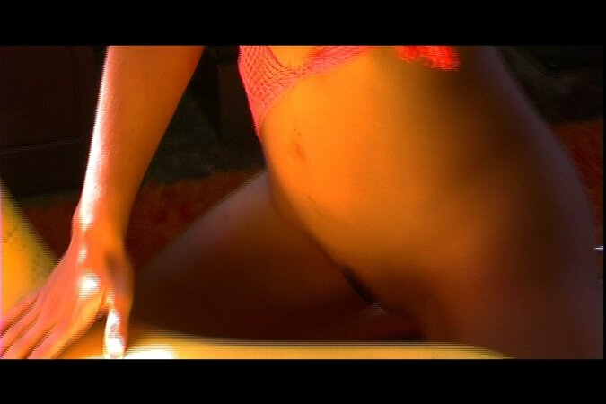 MILF from India Sunny Leone in orange lingerie poses on a yellow lounger
