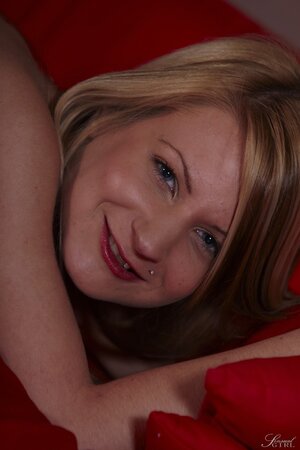 Slender blonde performs amazing strip show for lover on the red couch