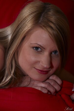 Slender blonde performs amazing strip show for lover on the red couch