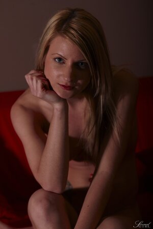 Slender blonde performs amazing strip show for lover on the red couch