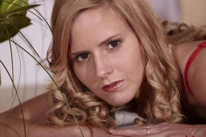 Bashful blonde with curly hair gladly poses without her red lingerie