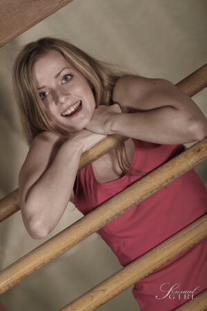 Good-looking sweetheart performs amazing striptease near wooden ladder