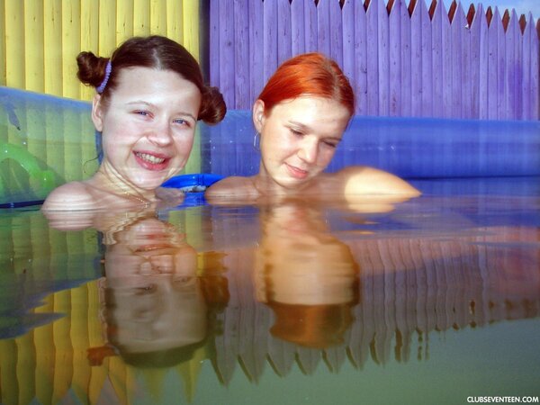 Lesbian teen with nice hairstyle dildoes redhead's pussy in air pool
