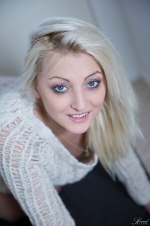 Blonde with beautiful face takes off panties and knitted sweater in the hallway