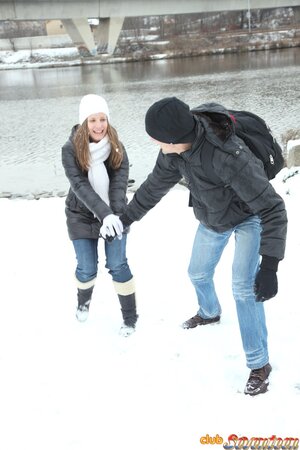 Spicy girl plays in the snow with young man and hurries home to play adult games