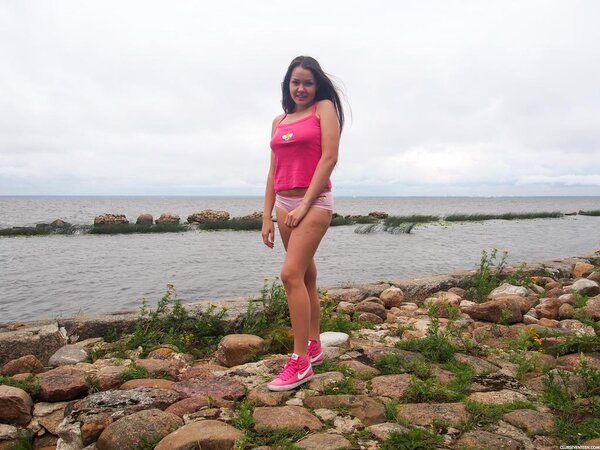 Tourist with tan lines gets undressed to fuck herself on the rocky beach
