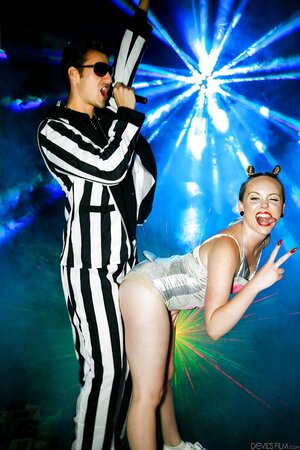 Party girl has fun with MC in the disco lights tempting him with naked ass