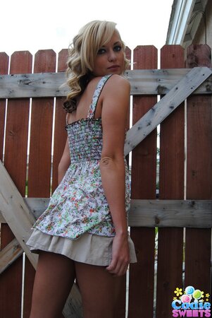 Naughty teen blonde teases with her tiny tits and shaved pussy outdoors