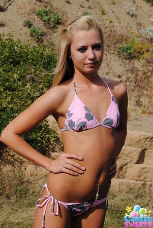 Sweet blonde slowly pulls sexy bikini down to demonstrate her slim body