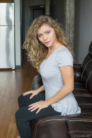 Young blonde candy strips naked and poses on the couch for the very first time