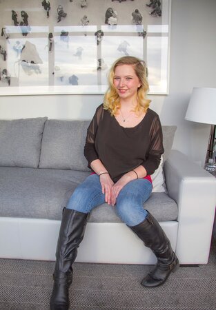 Amateur blonde undresses and exposes her fantastic huge tits on the couch