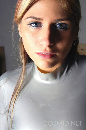 Slim gal teases with the view of her pierced nipples showing through latex shirt