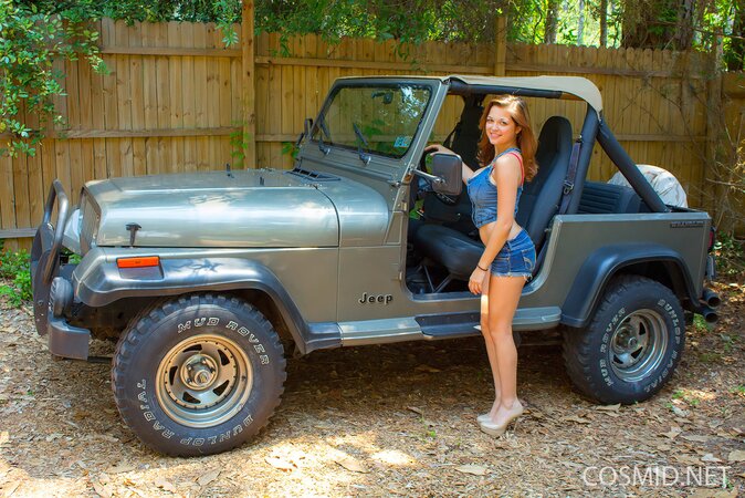Blonde hussy gets into the jeep and teases with her immense naked breasts