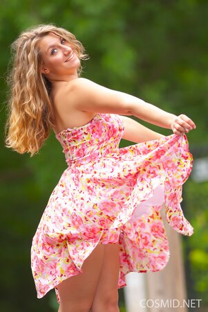 Beauty with wavy hair flashes her natural tits and lovely ass outdoors