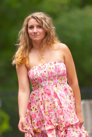 Beauty with wavy hair flashes her natural tits and lovely ass outdoors