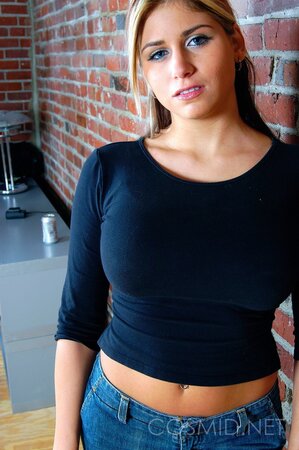 Sultry towheaded gal slowly strips to black lingerie to reveal her perfect curves