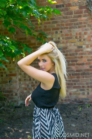 Blonde demonstrates her massive natural breasts and round ass outdoors