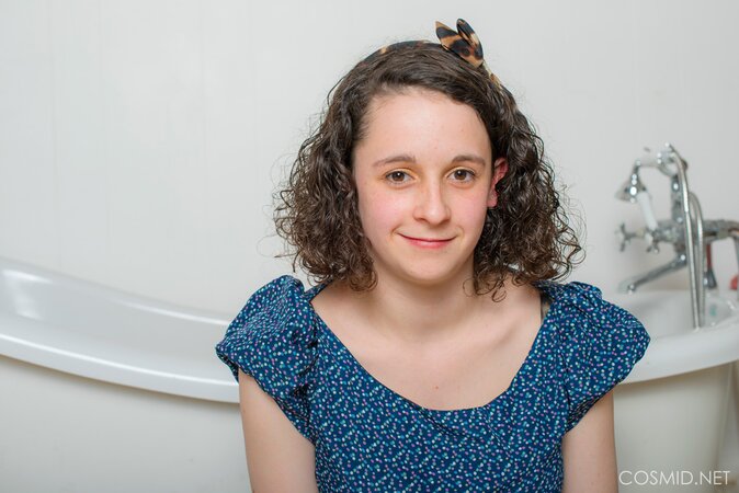 Amateur curly-haired chick Hanna Bollie in stockings teases with her big tits