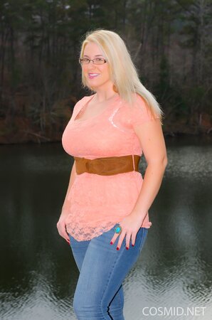 Erotic outdoor session of stunning blonde MILF showing big breasts at the lake