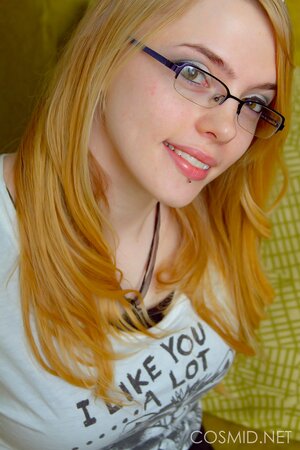 Beauty with glasses looks sexy when stripping to lingerie to show her breasts