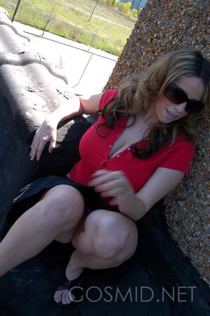 Busty whore in red top gets on the roof and teases with her big boobs