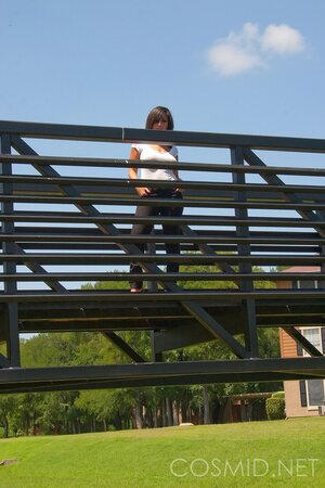 Amateur whore in slinky dress teases with her big tits when posing outdoors