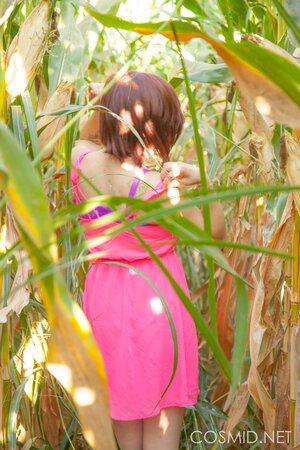Slutty MILF with glasses takes off clothes to pose naked in the cornfield
