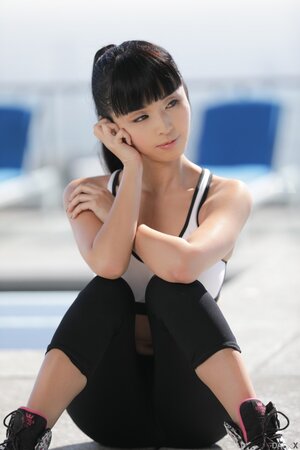 Petite Asian MILF strips off and teases with her fit naked body on the roof
