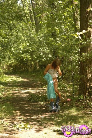 Freckle-faced girl with red hair comes to the forest where she takes off pants