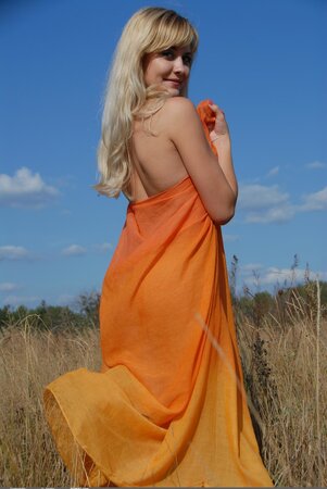 Blonde finds a beautiful sunflower that she uses during the nude photo session