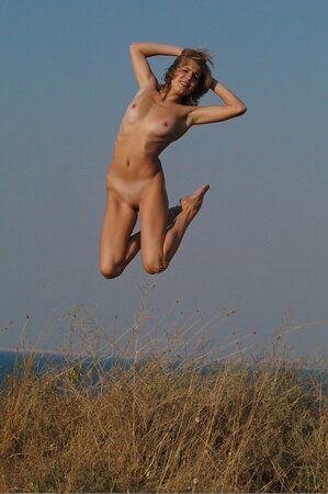 Attractive teen with sexy tan lines relaxes completely naked under the sun