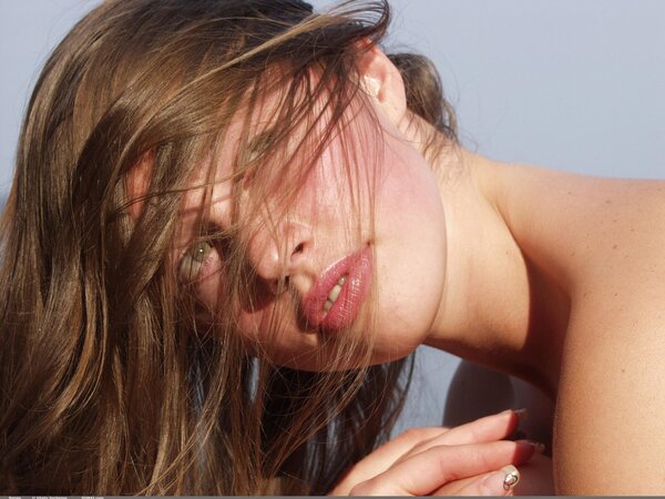 Ravishing brunette provocatively demonstrates assets during shoot in the water