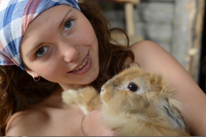 Farmer's playful daughter fools around naked with animals in the barn
