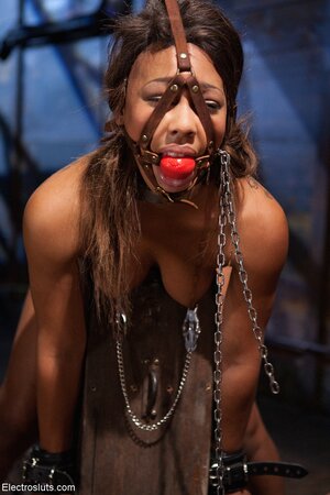 Gagged black slave bitch has her ass and pussy stuffed with electric dildos