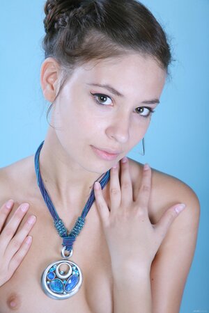 Skinny Russian pornstar with tiny ass poses with flower and blue necklace on