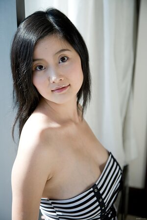 Skinny oriental teen Elva Tan flaunts tits and booty in the wooden closet