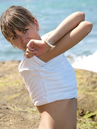 Tiny young babe with hairy pussy flaunts her beautiful body on the beach
