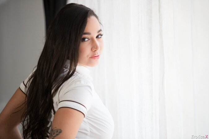 Natural girl Karlee Grey in student shirt and skirt strips naked by the window