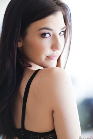 Petite girl with black hair has pale body under robe and lingerie to expose