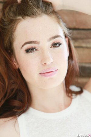 Photographer takes pics of the red-haired girl's face before she undresses