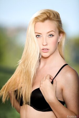 Mesmerizing blonde beauty slowly removes lingerie posing in the nude on the roof