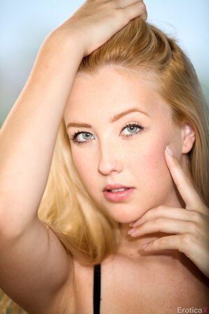 Mesmerizing blonde beauty slowly removes lingerie posing in the nude on the roof