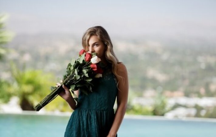 Sultry blonde with a bunch of flowers takes off cute dress when posing nude