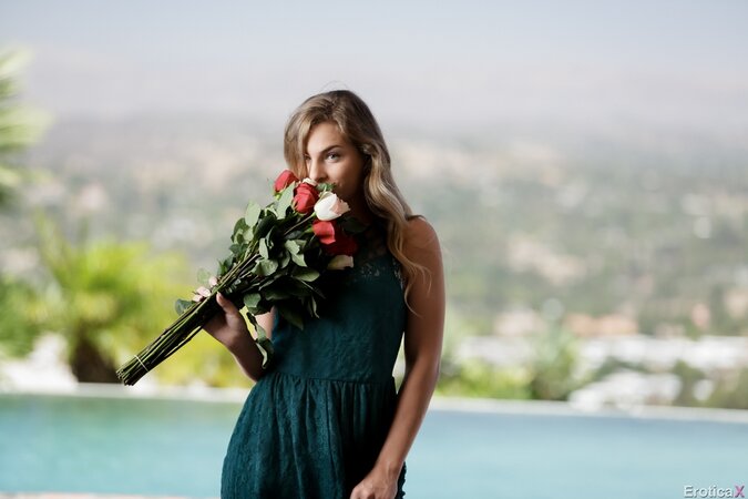 Sultry blonde with a bunch of flowers takes off cute dress when posing nude