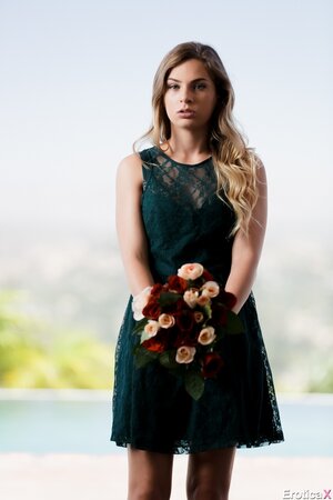 Sultry blonde with a bunch of flowers takes off cute dress when posing nude
