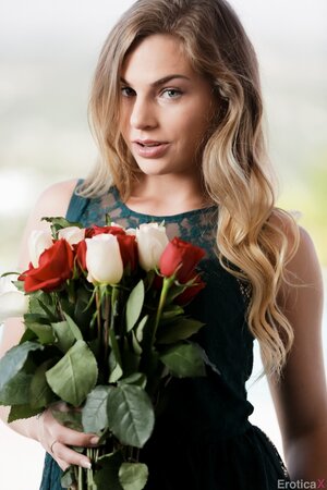 Sultry blonde with a bunch of flowers takes off cute dress when posing nude