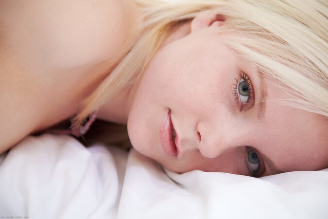 Sweet blonde angel willingly demonstrates her small tits early in the morning