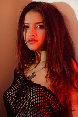 Cutie gently touches own pussy after freeing skinny body from fishnet shawl