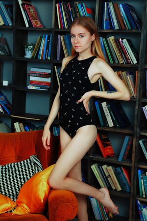 Teen nerdy bitch spends time stripping and posing naked in the library