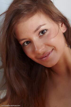Petite brown-eyed teen flaunts her naked body posing like a pro on the floor